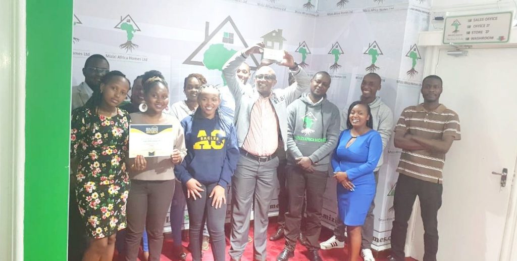 Mr.George Mburu,CEO,Mizizi Africa Homes with the company staff(photo;courtesy)